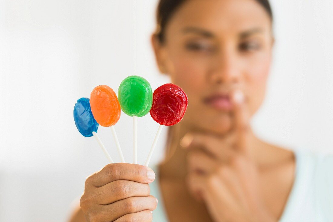 Woman holding colorful lollypops