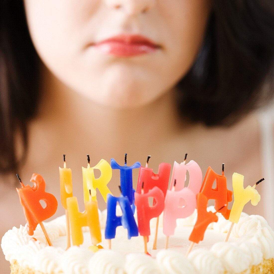 Woman frowning at blown out birthday candles