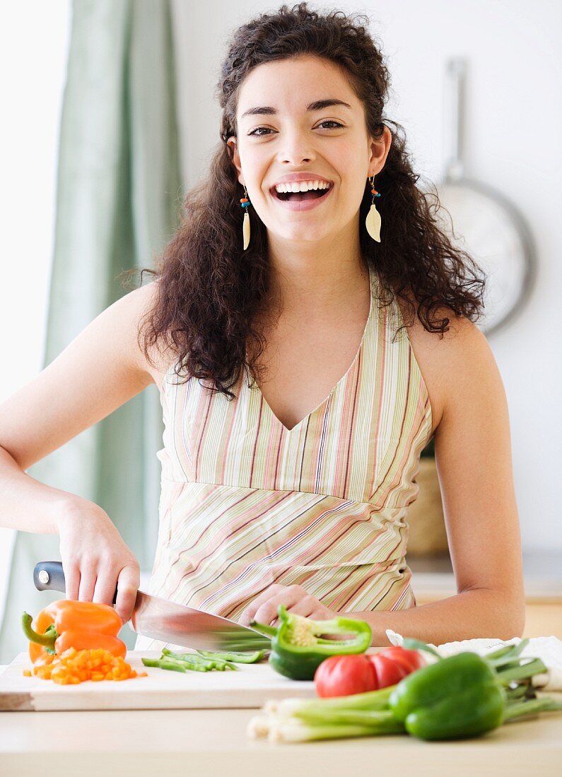 Young woman slicing vegetables