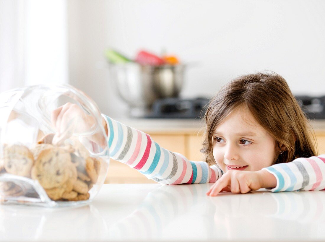 Girl reaching into cookie jar