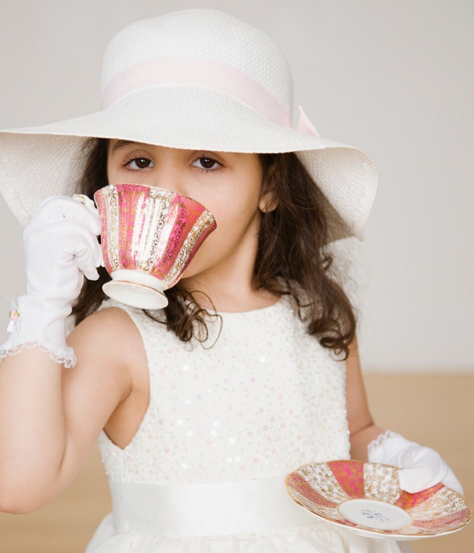 Hispanic girl dressed up at tea party