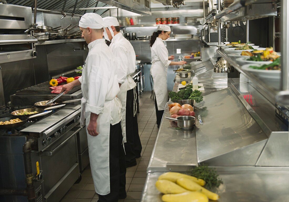 Chefs preparing food in kitchen