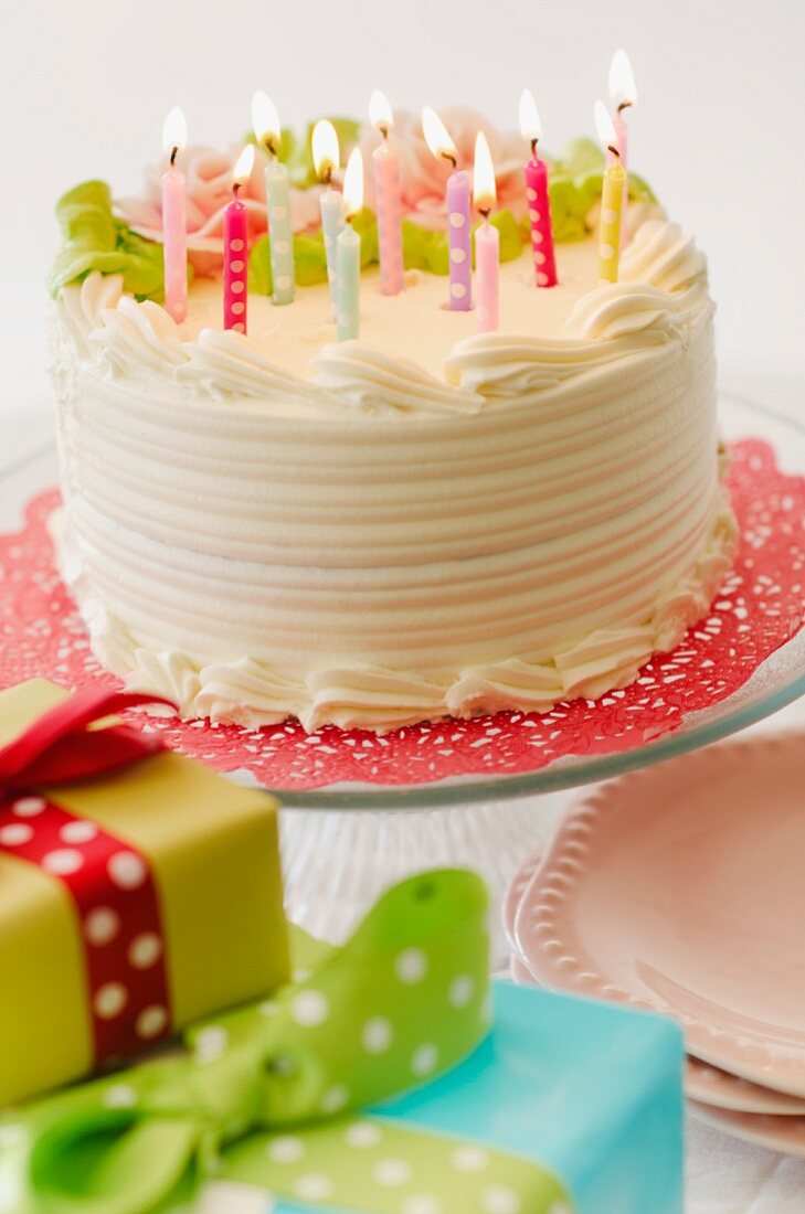 Studio shot of colorful birthday cake and birthday gifts