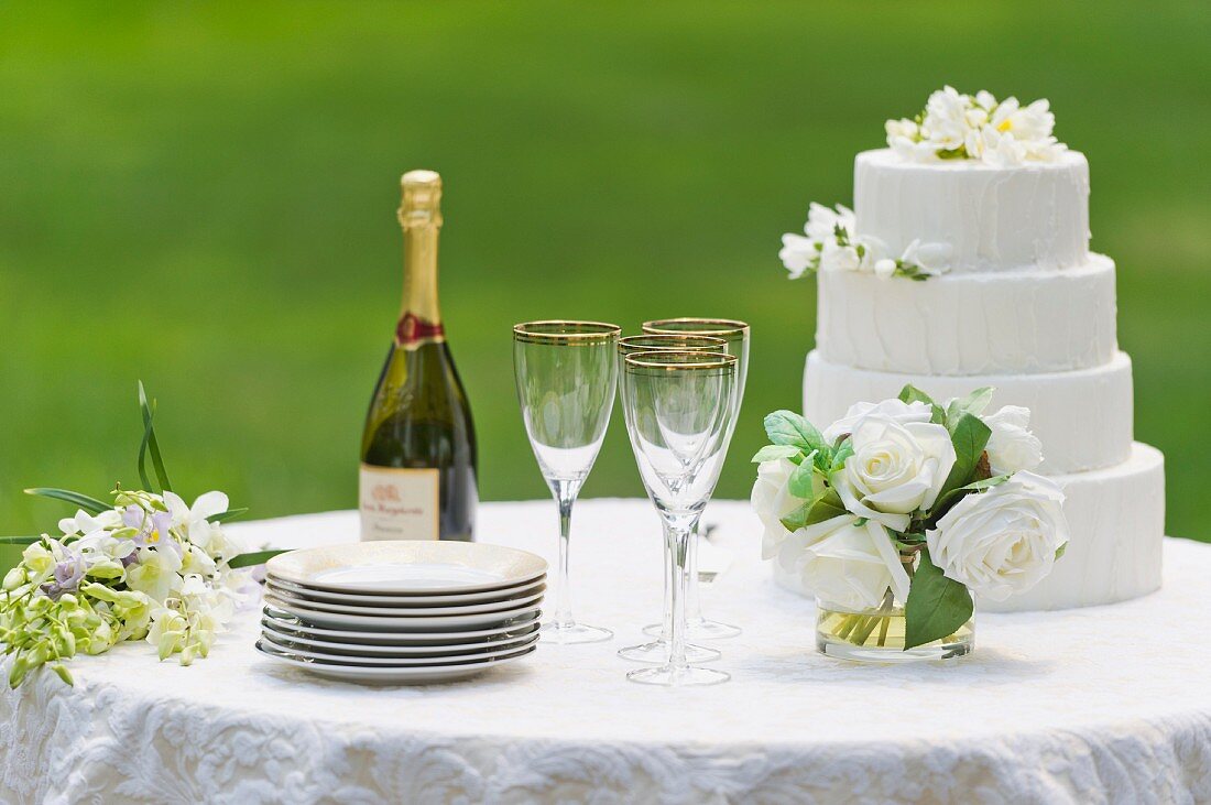Table with champagne bottle and wedding cake