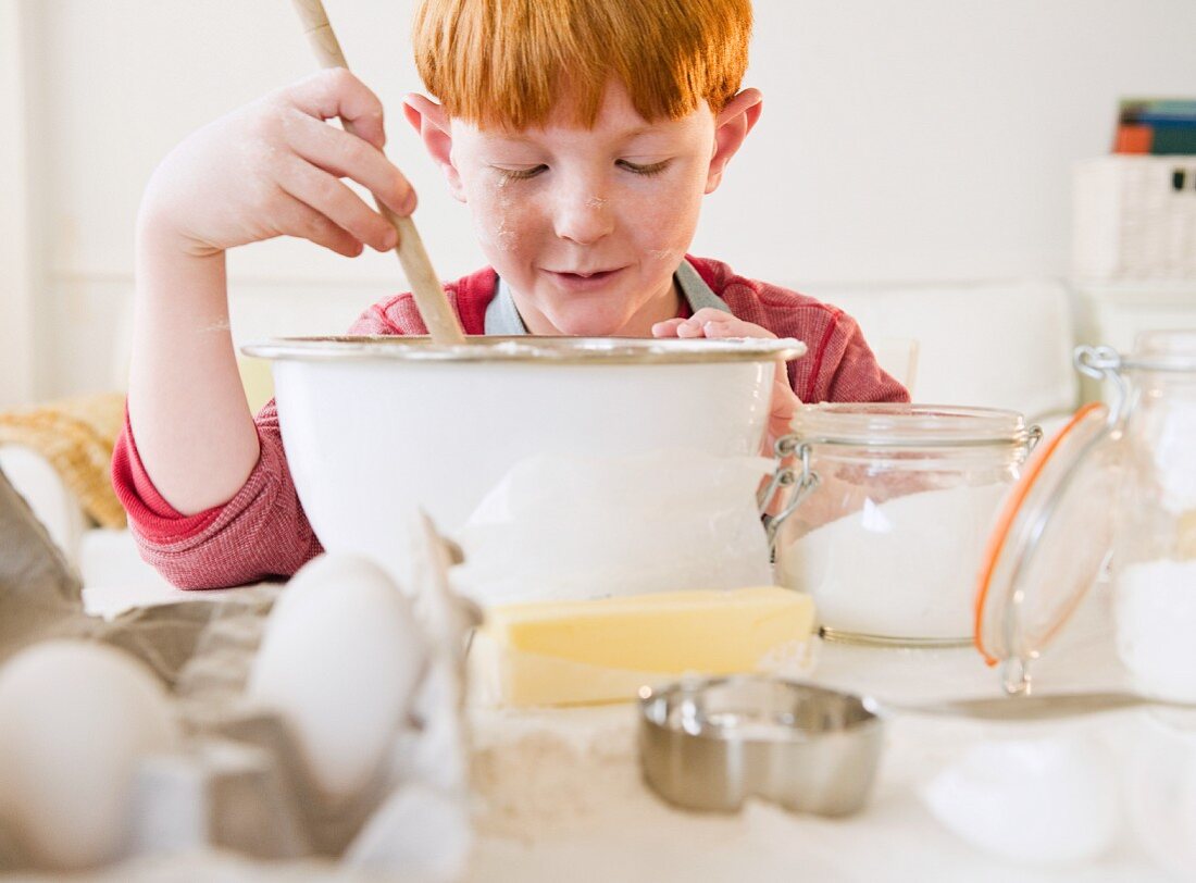 Portrait of boy (8-9) preparing cake