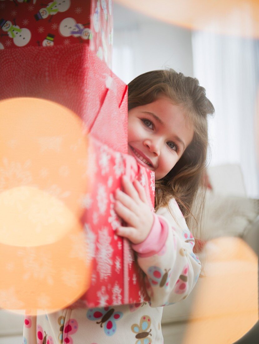 Small girl (4-5 years) carrying Christmas presents