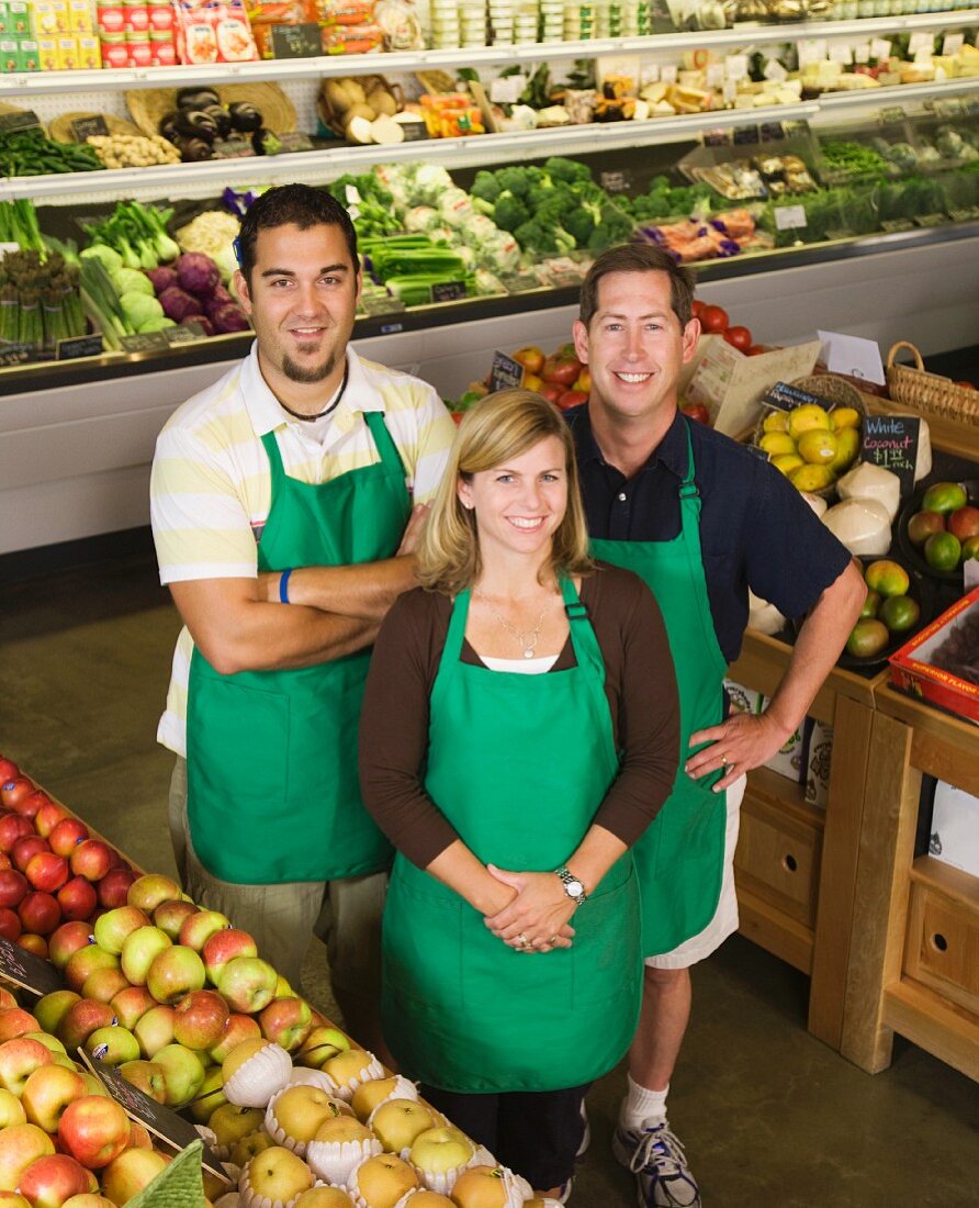 Workers posing in produce section
