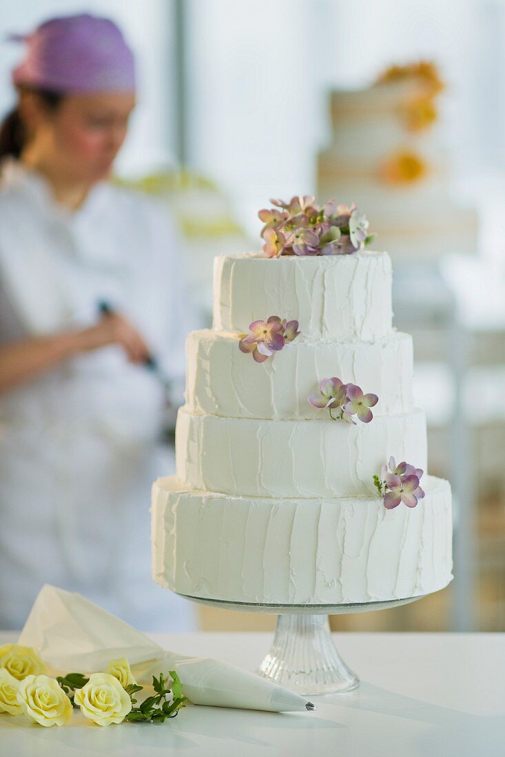 Wedding cake, pastry chief in background