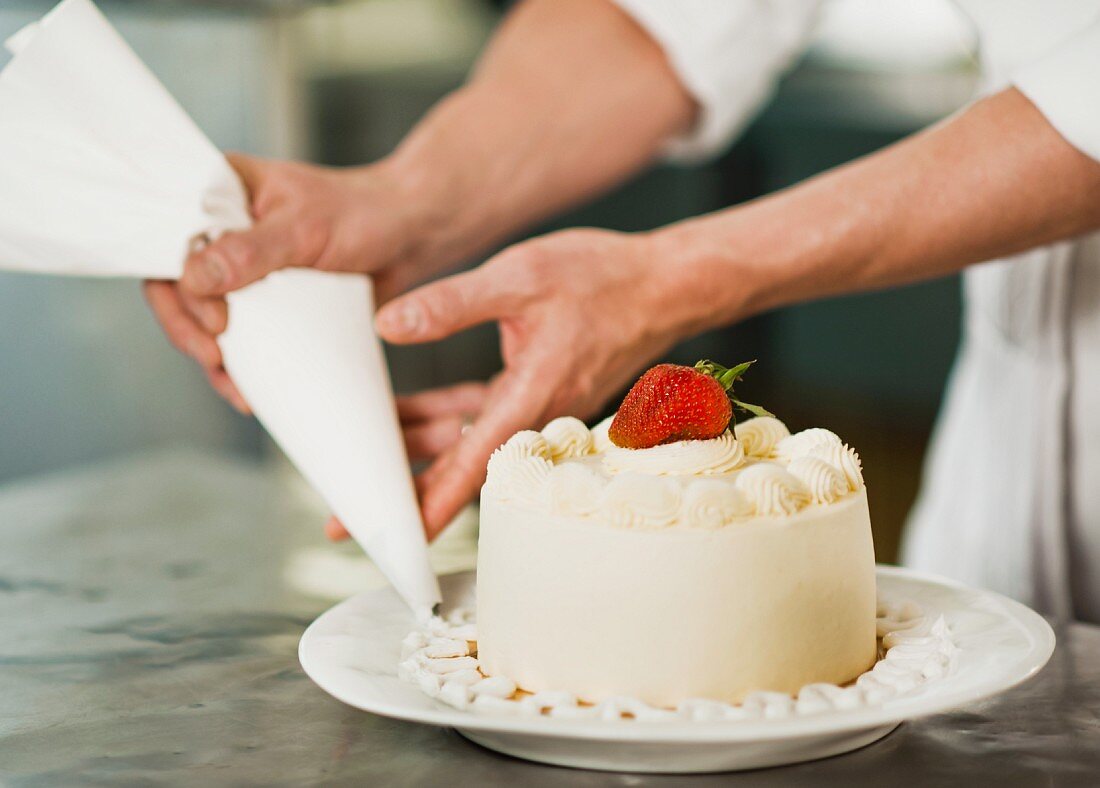 Pastry chef decorating cake