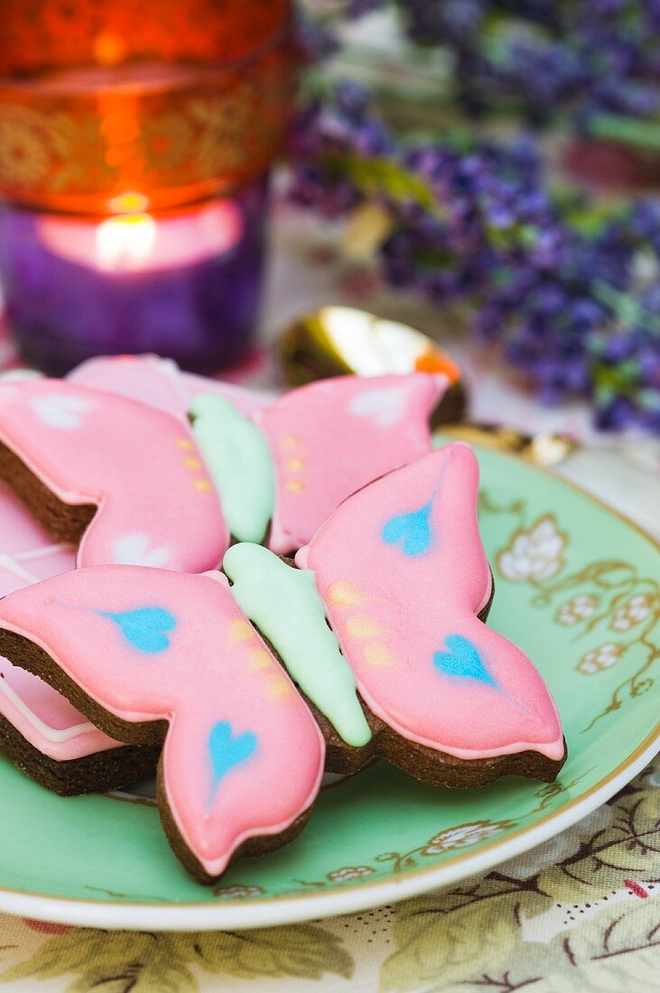 Butterfly cookies in a tea cup with saucer. Tea light. Lavender.