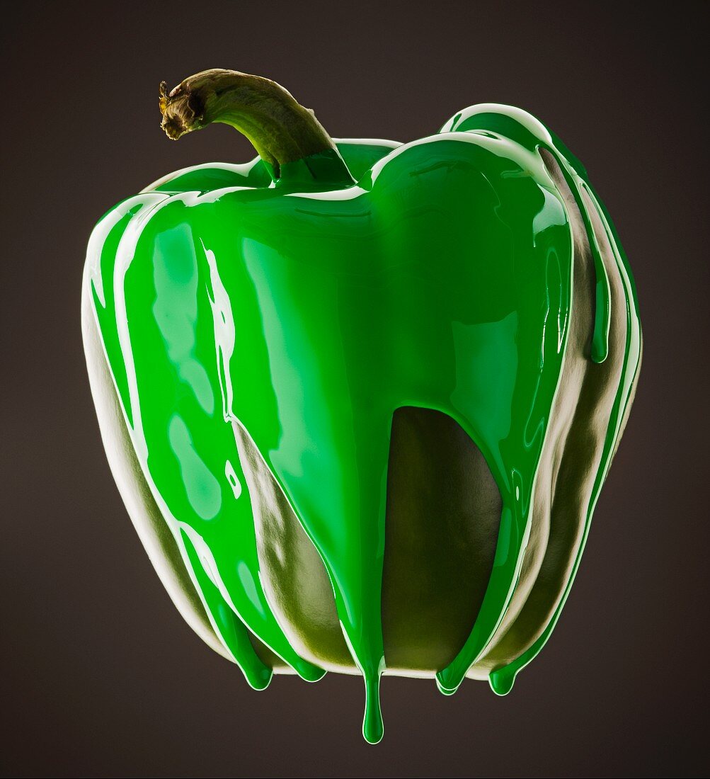 Studio shot of green pepper covered with green paint