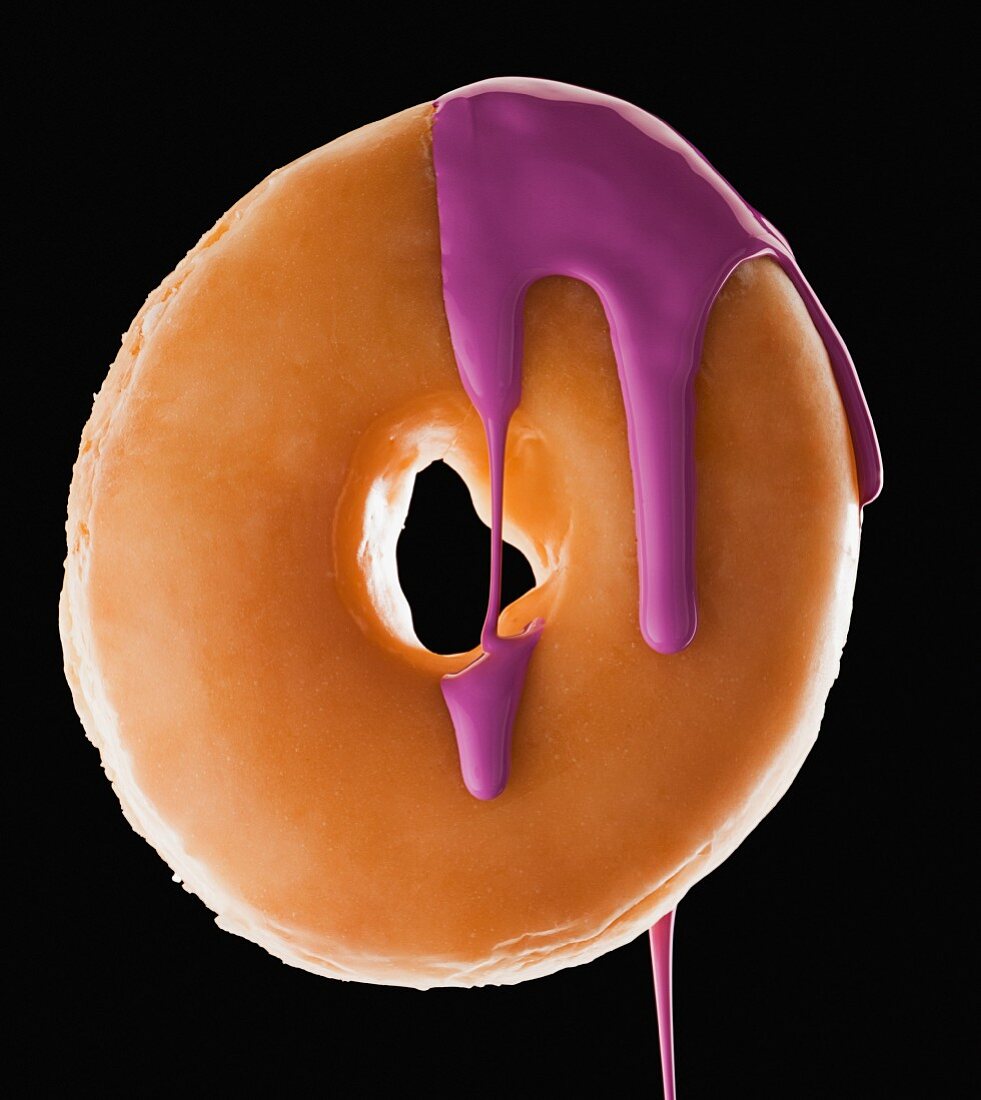 Studio shot of doughnut with purple paint