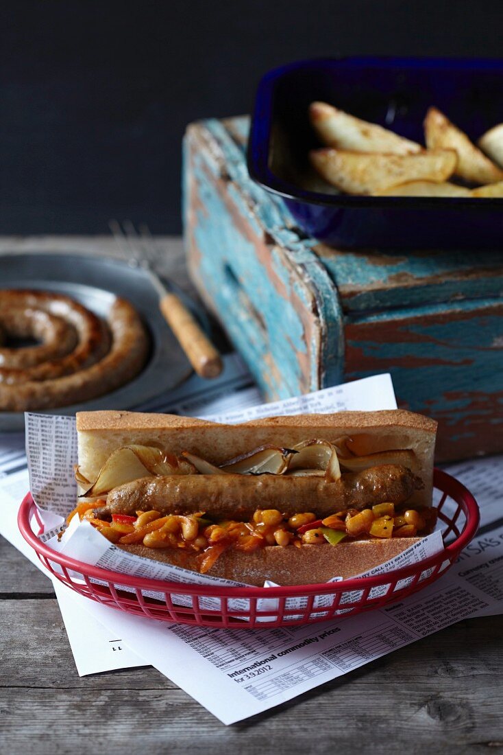 Baguette roll with spiral sausage, peppers and potato wedges