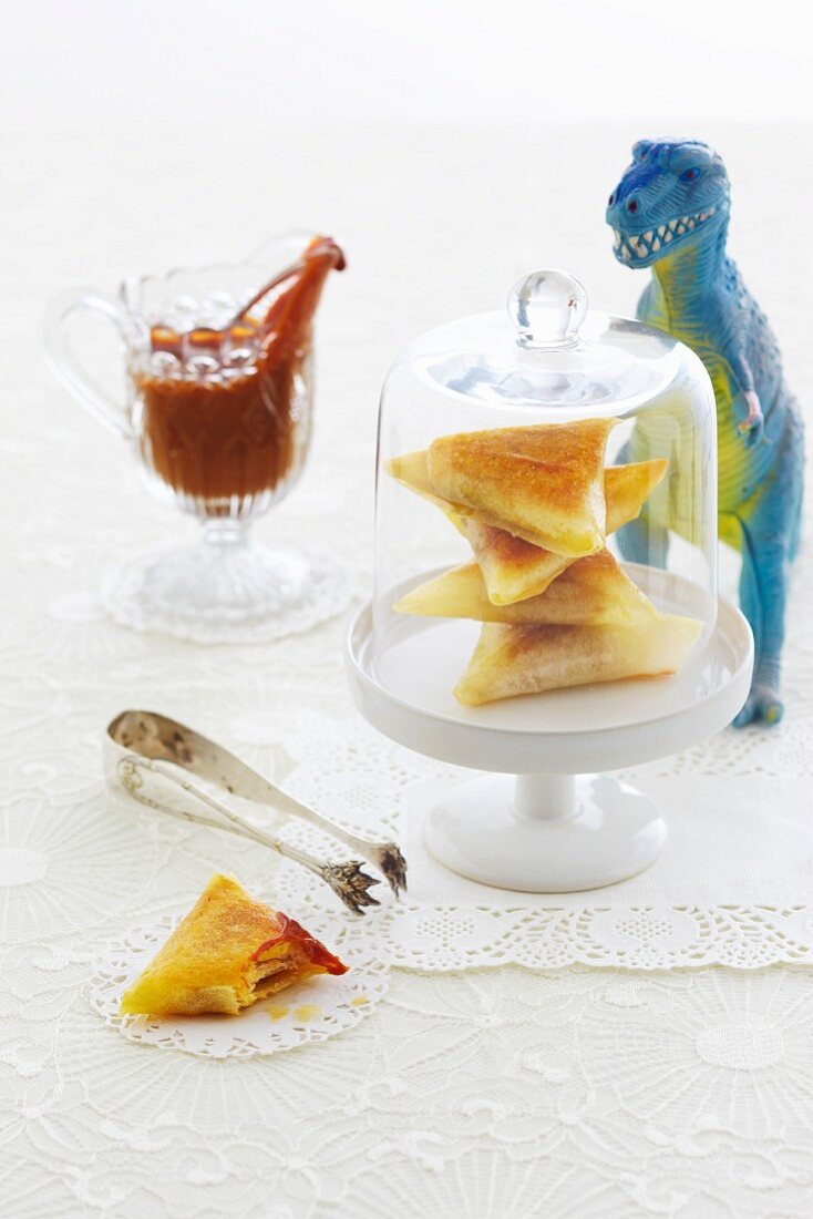 Sandwich triangles in a cheese cover with a toy dinosaur