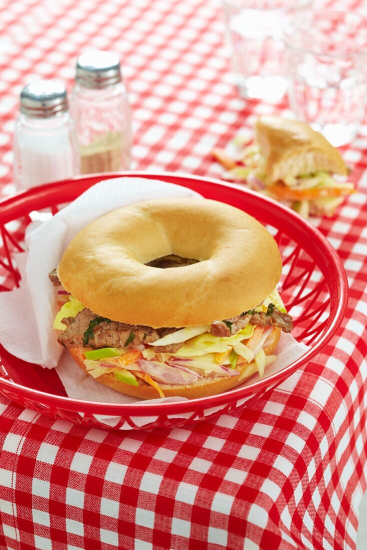 Bagel with meat and vegetables