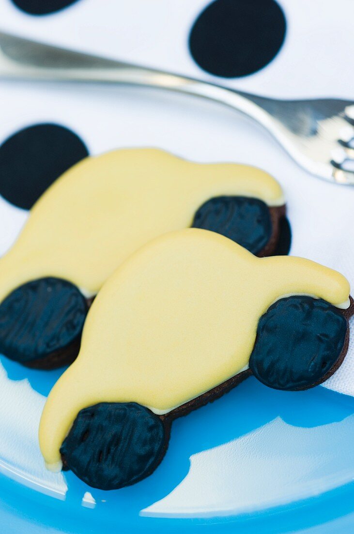 Yellow 'car' cookie on a plate with a fork