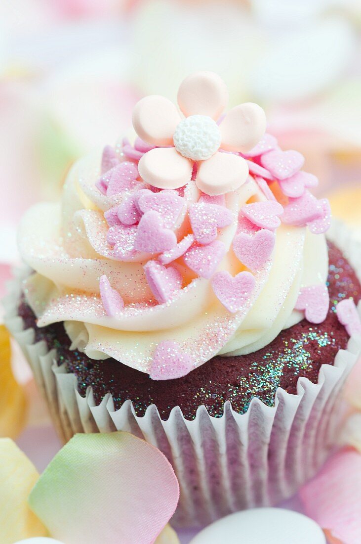 Chocolate cupcake decorated with pink sugar hearts