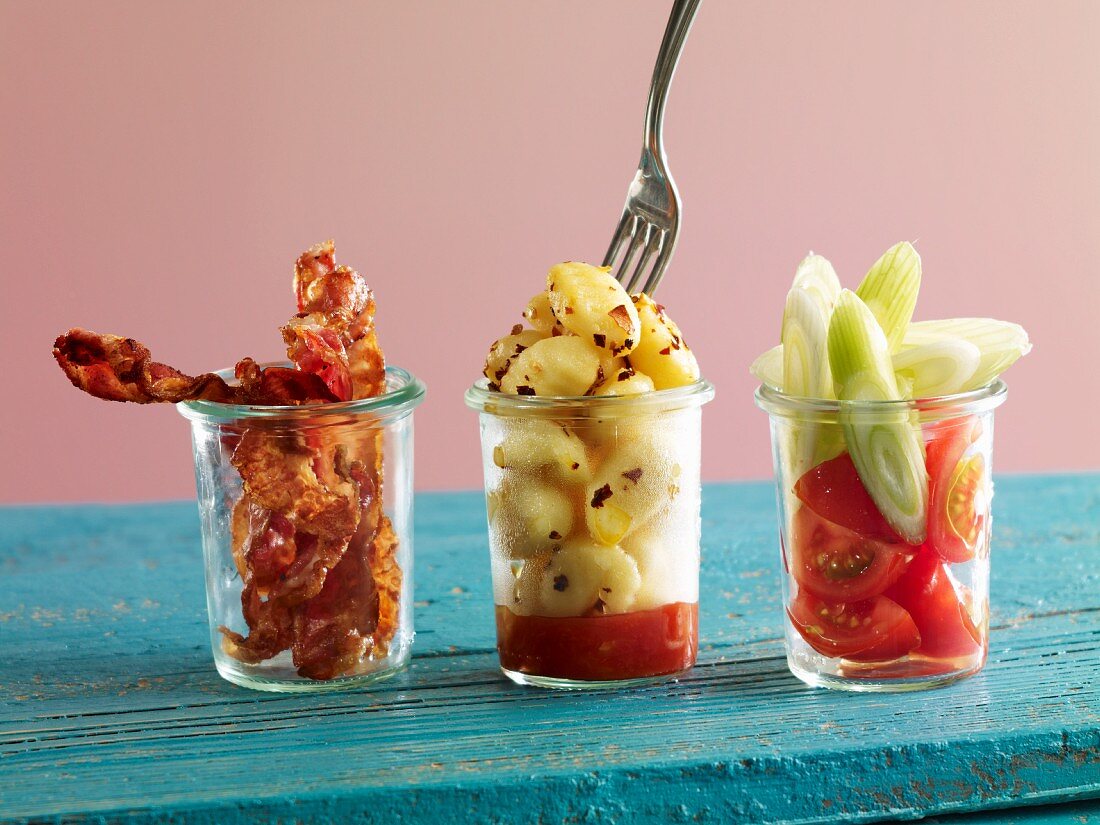 Gnocchi with fried bacon and tomato-fennel salad in glasses