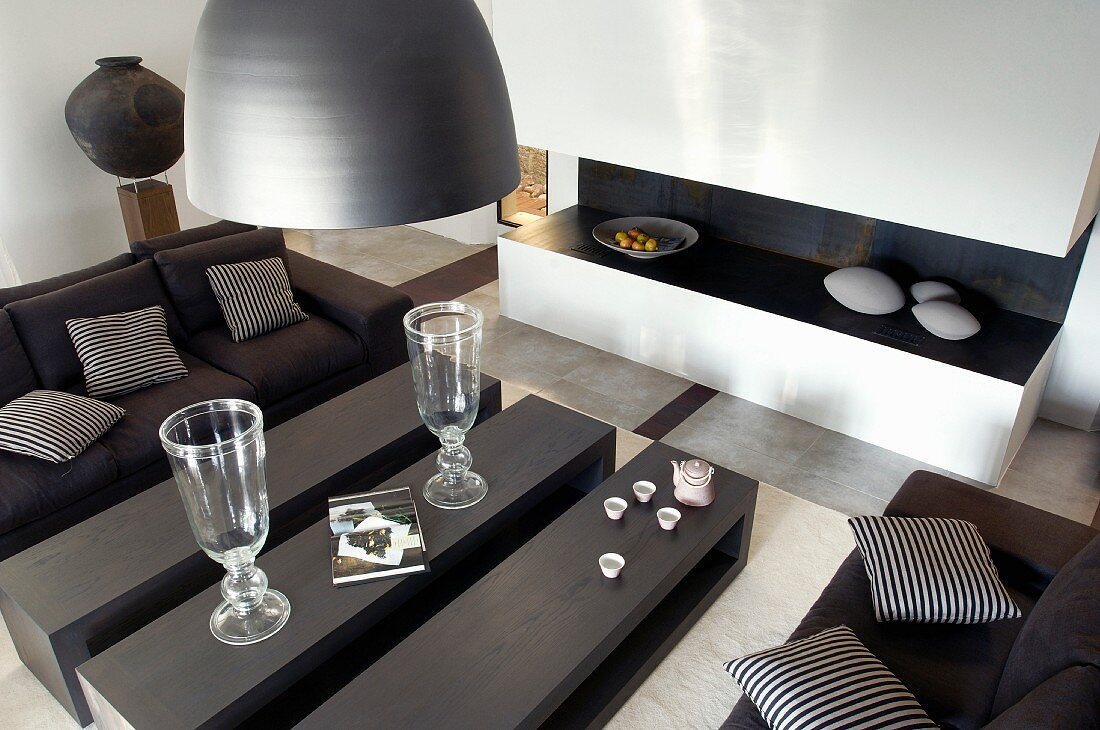 Coffee table in three sections and dark sofa set in contemporary living room