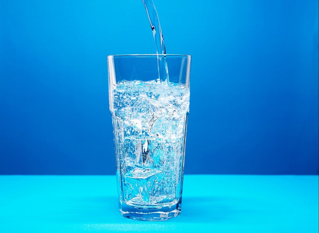 Pouring mineral water into a glass