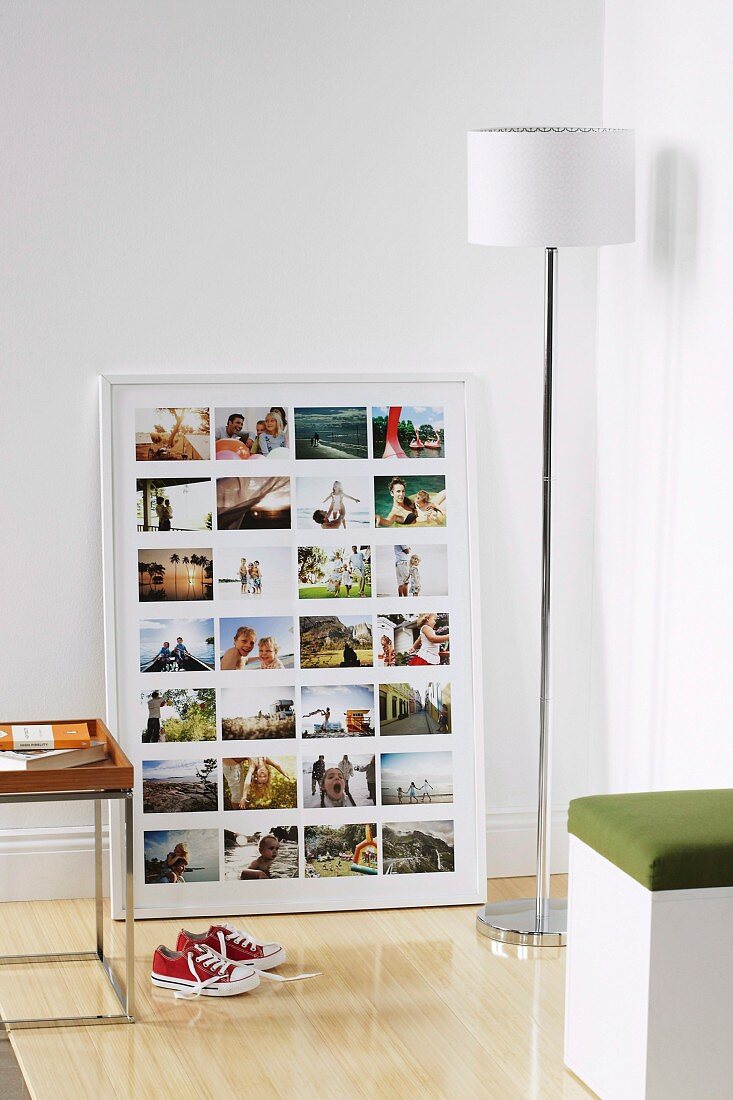 Collage of family photos in white frame and white standard lamp in corner