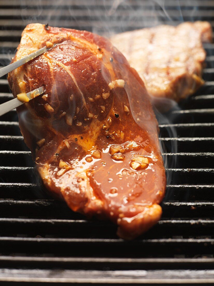 Marinated pork steak on the barbecue
