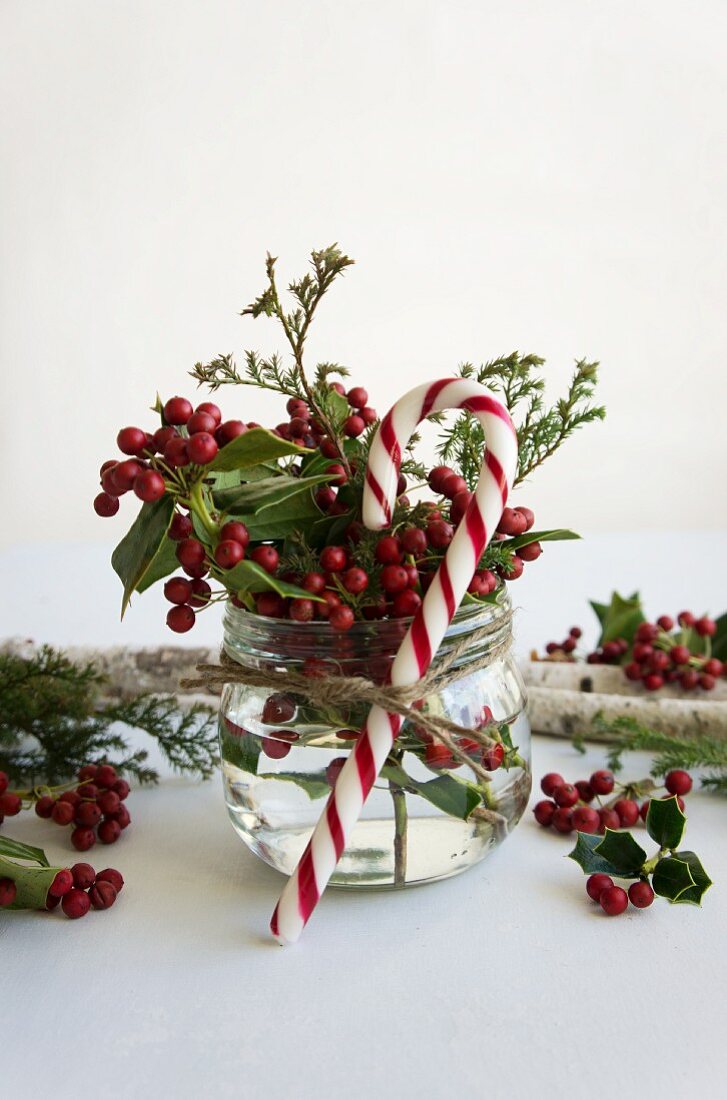 Posy of holly berries and candy cane