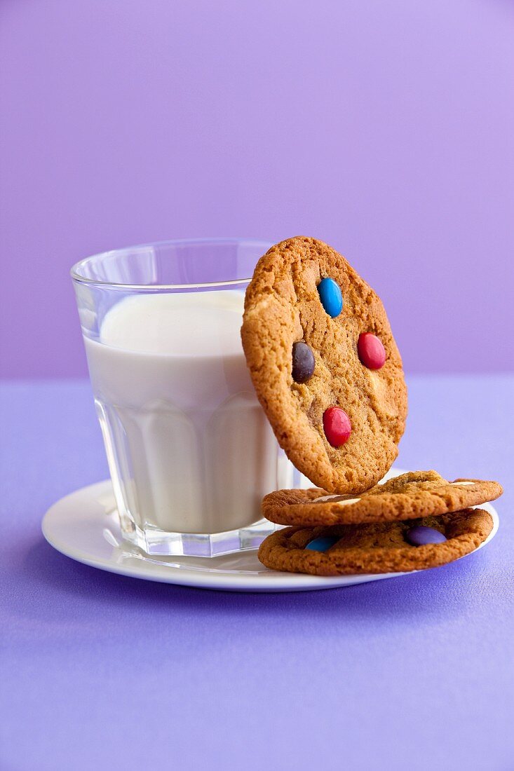 Cookies with M&Ms (chocolate candies) and a glass of milk