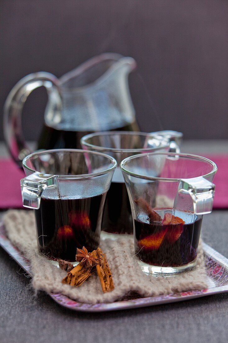 Mulled wine in glasses and a glass pitcher