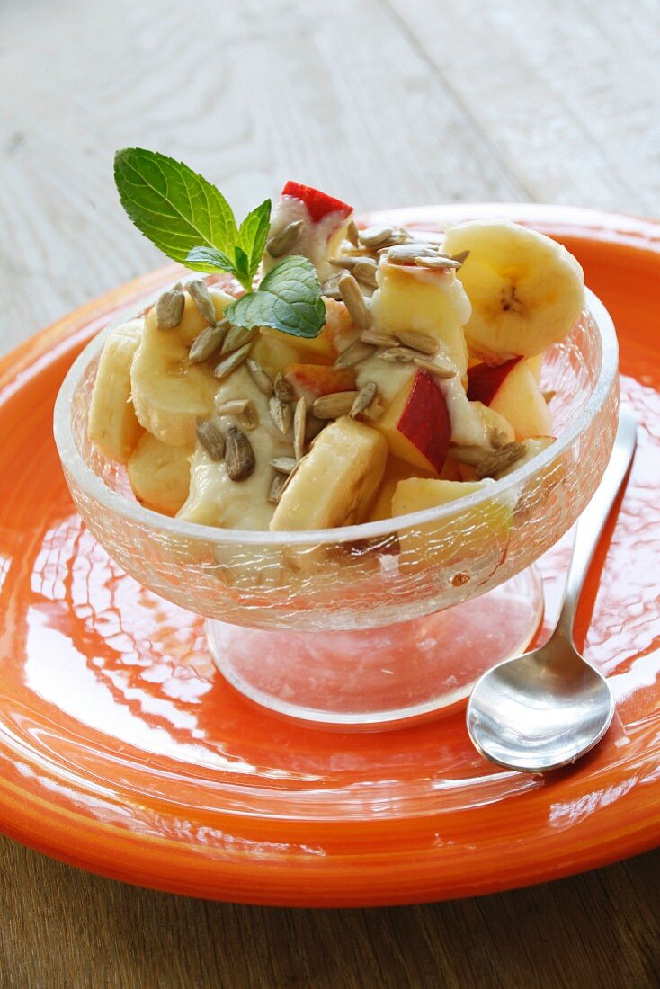 Yogurt muesli with apple, bananas and sunflower seeds