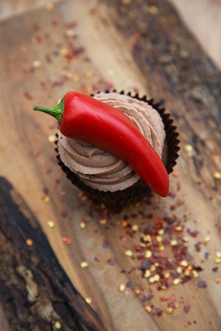 Hot chili pepper with a chocolate cupcake