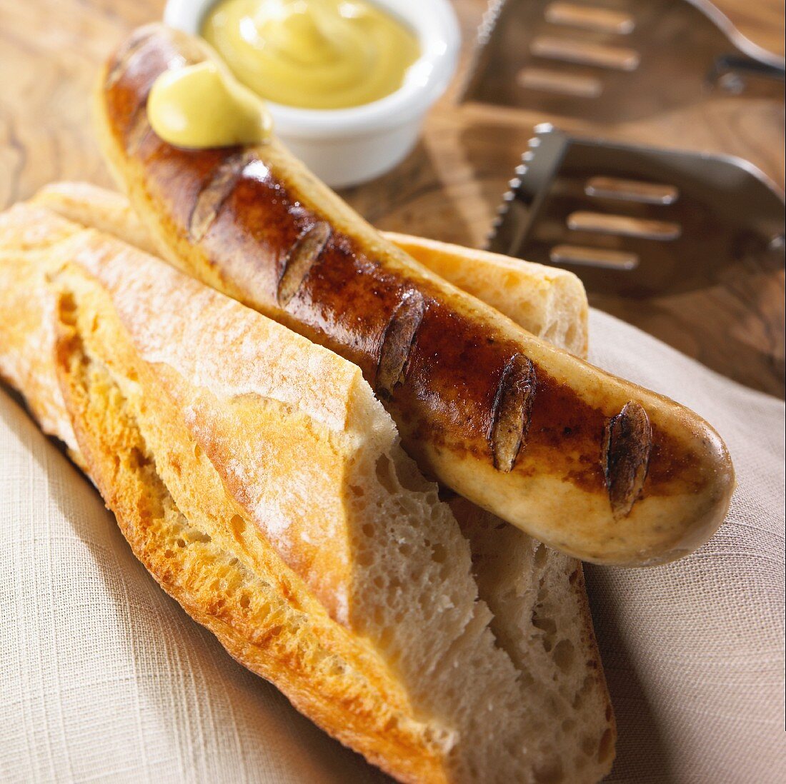 Grilled bratwurst with baguette and mustard