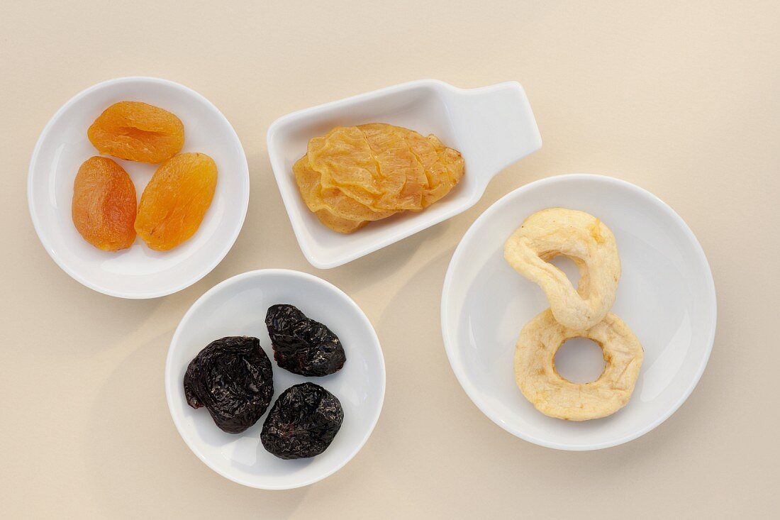 Assorted dried fruits in dishes (overhead shot)
