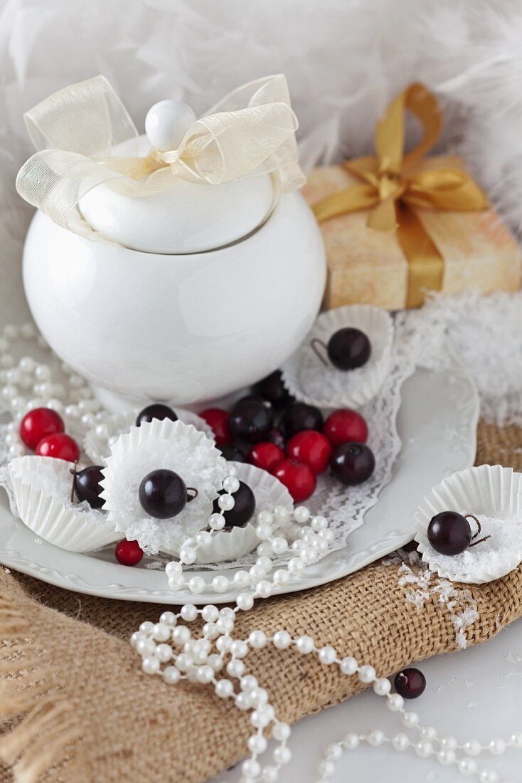 Christmas decorations with a covered china pot, ball ornaments and a string of pearls