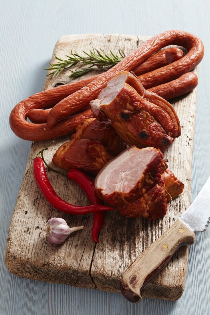 Smoked meat and sausages on a wooden cutting board