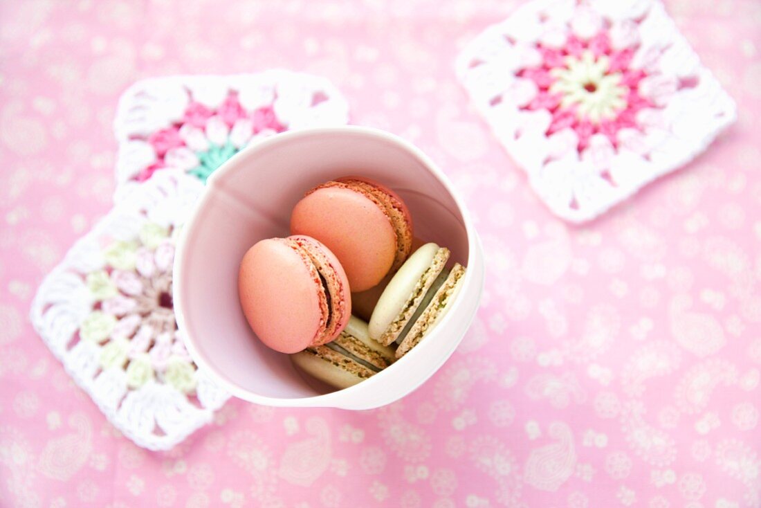 Colorful macaroons in a paper cup