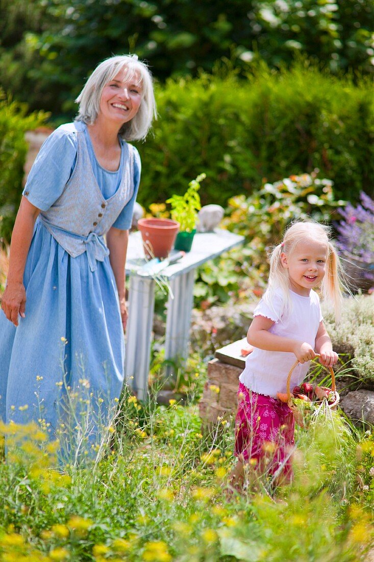 Frau mit Mädchen im Garten