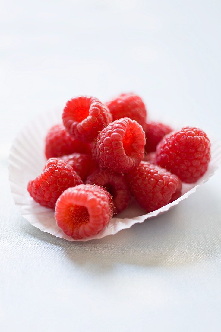 Fresh raspberries in a paper baking cup