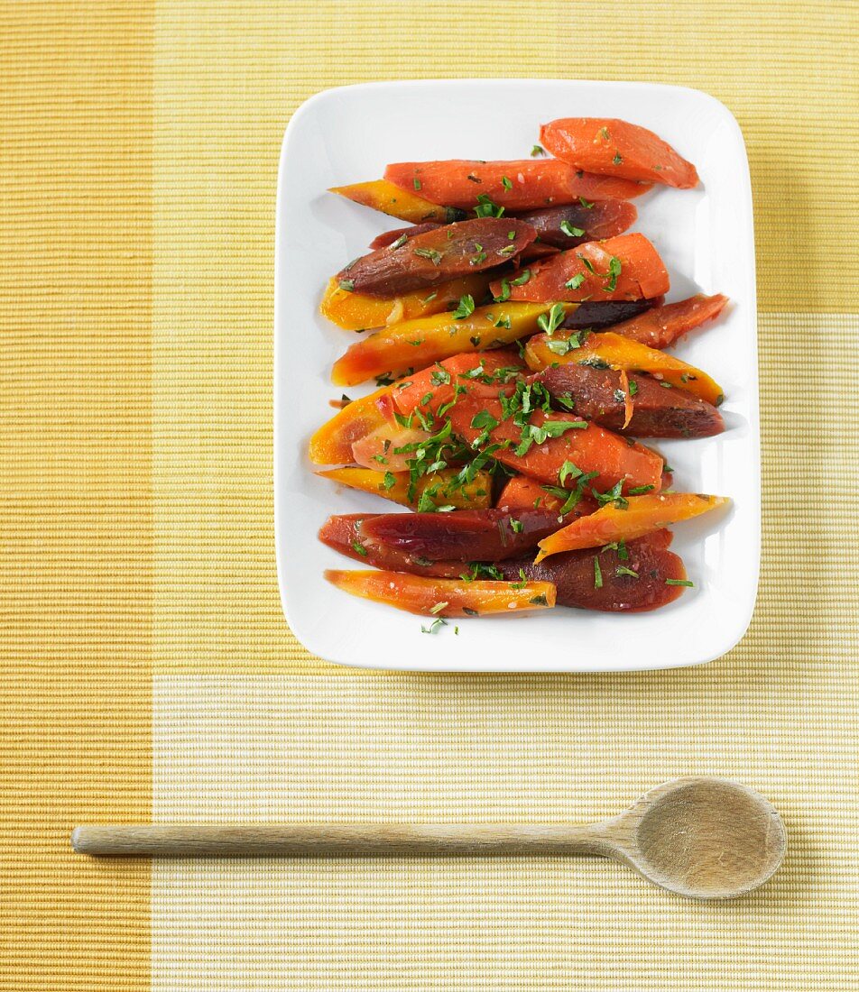 Cooked Organic Rainbow Carrots with Parsley on a Serving Platter; From Above