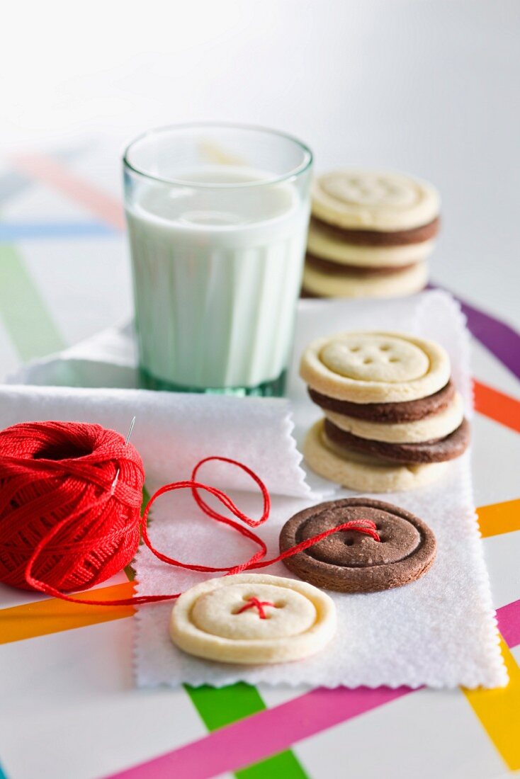 Button-shaped biscuits and a glass of milk