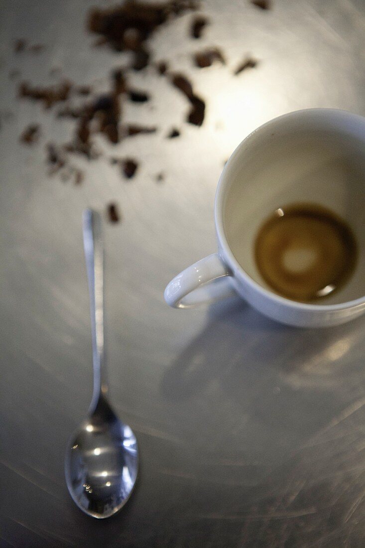 An espresso cup with the remains of a cup of coffee