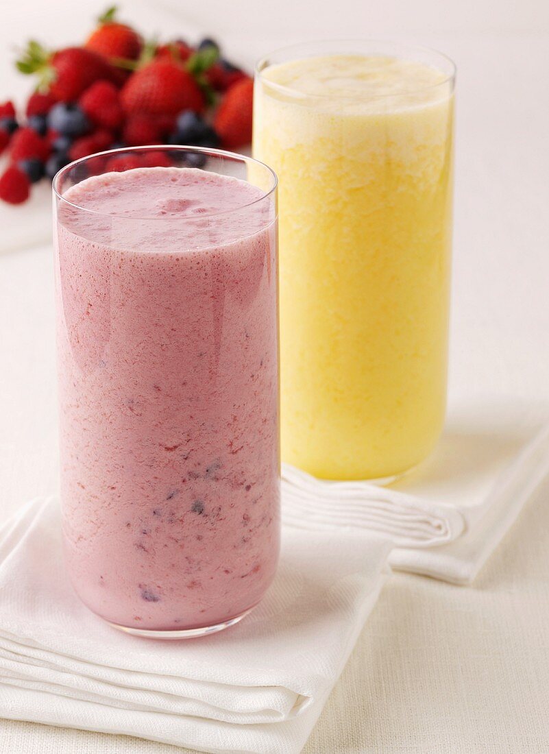 A strawberry smoothie and a banana smoothie