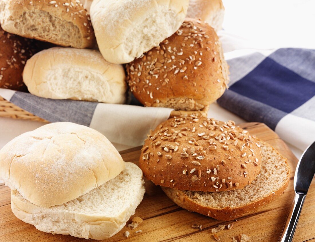 Assorted rolls, some sliced in half, some in a bread basket