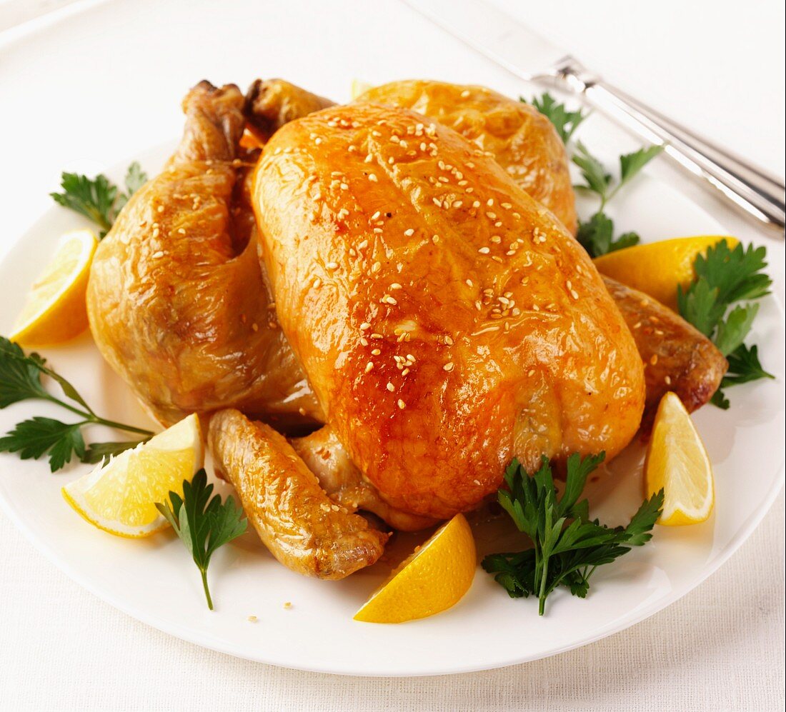 A whole roast chicken with sesame seeds