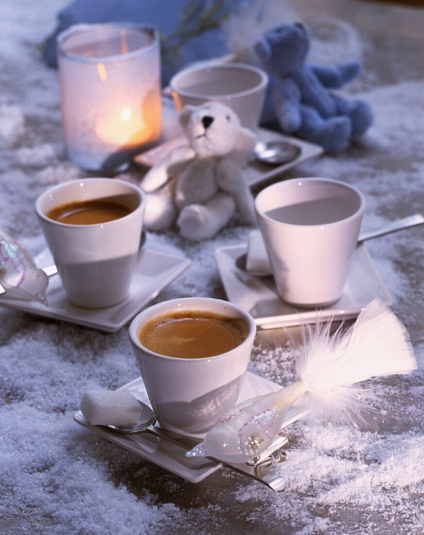 Cups of coffee with a Christmas tree decoration and teddy bears