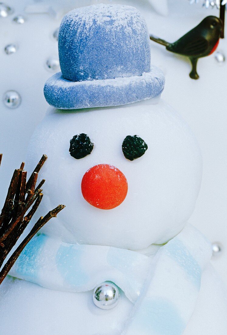 close up of icing snowman with hat
