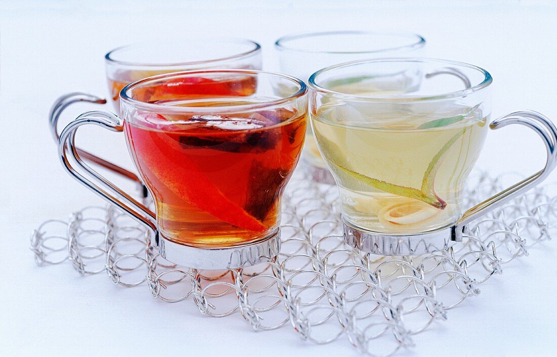 glass cups of black and white tea on a cooling rack
