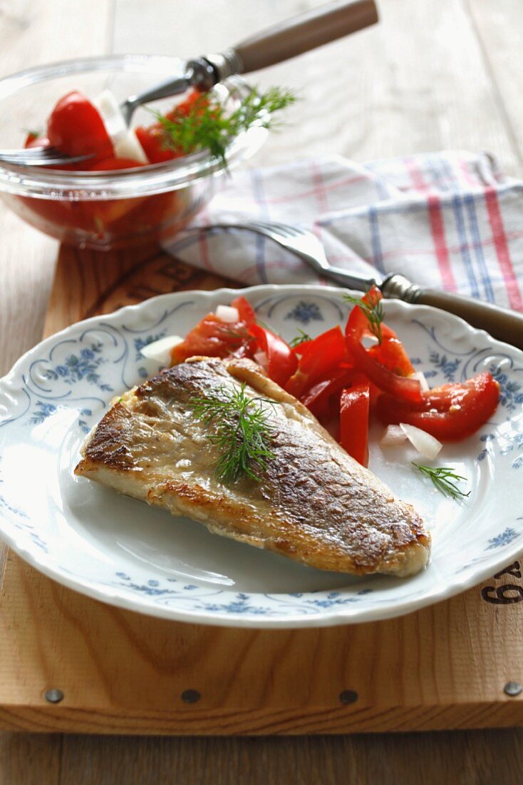 Fried coalfish with tomato salad