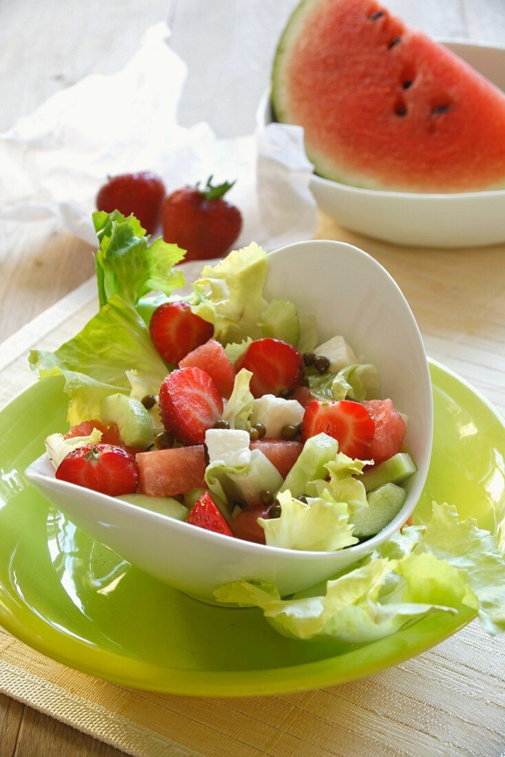 Melon salad with cucumber, mozzarella and strawberries