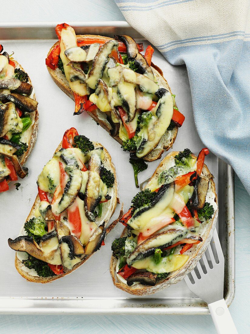 Bread topped with barbecued vegetables and cheese and then grilled
